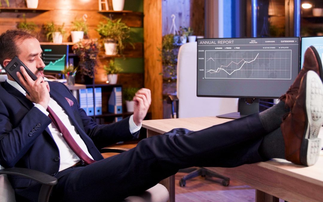 Businessman talking on the phone with his feet on the table