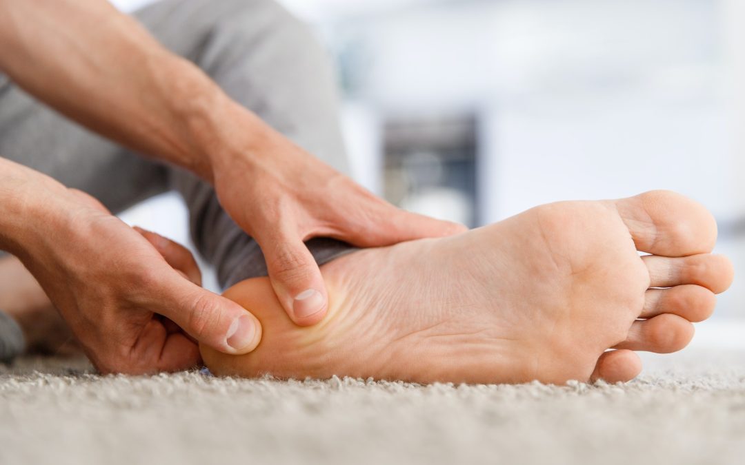 Man hands giving foot massage to yourself after a long walk